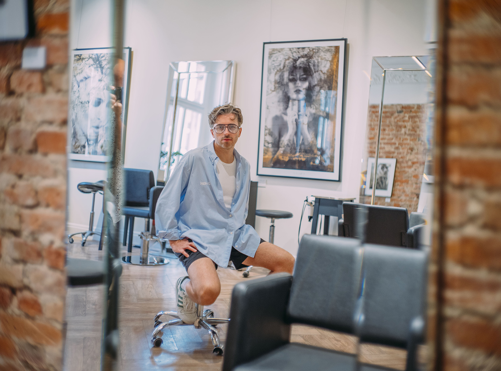 a young man sitting in a chair in a hairdressing salon - conversation graphic