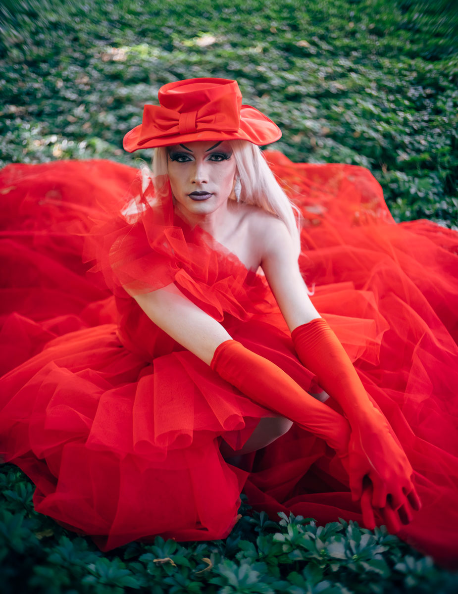 young man in red dress, hat and heavy makeup - conversation graphic