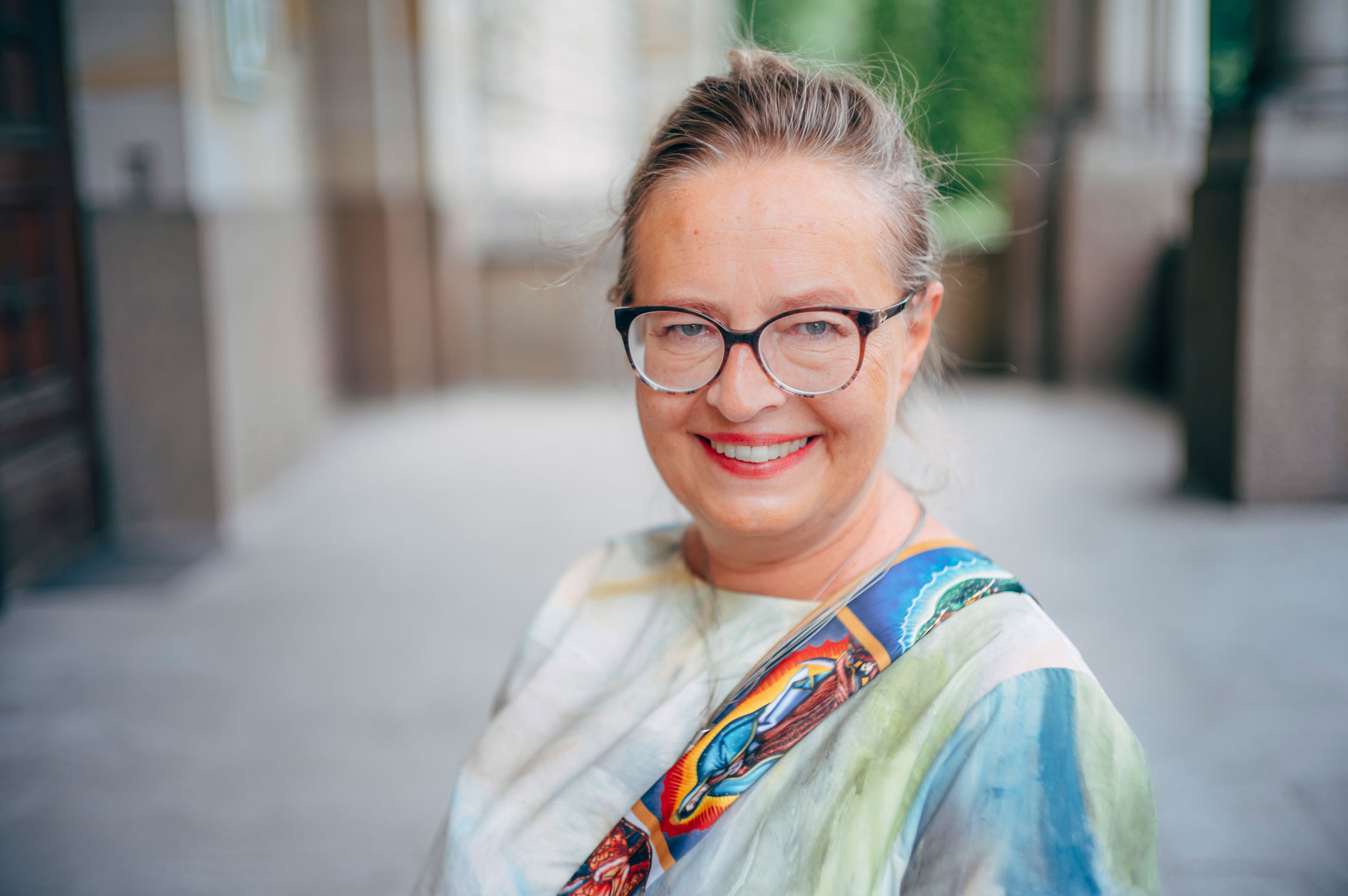 woman in glasses smiling - conversation graphic
