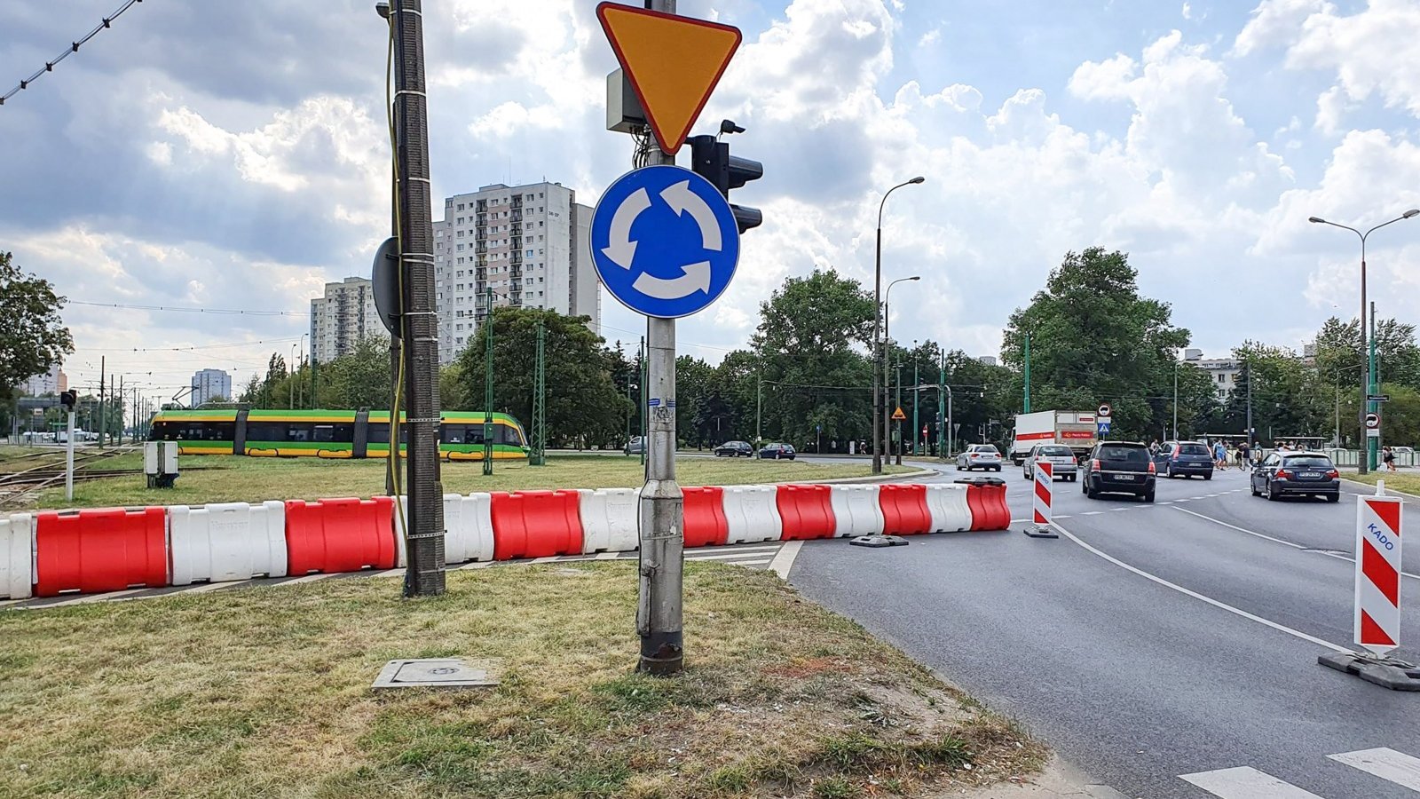 Na zdjęciu widać jezdnię, samochody i zamknięty (odgrodzony pachołkami) pas ruchu