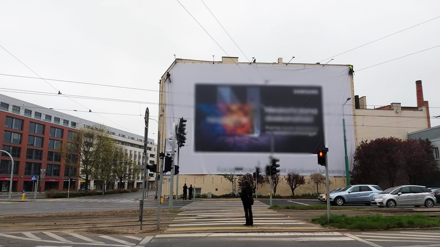 Galeria zdjęć przedstawia wielkoformatowe nieleglane reklamy zainstalowane na budynkach w centrum miasta.