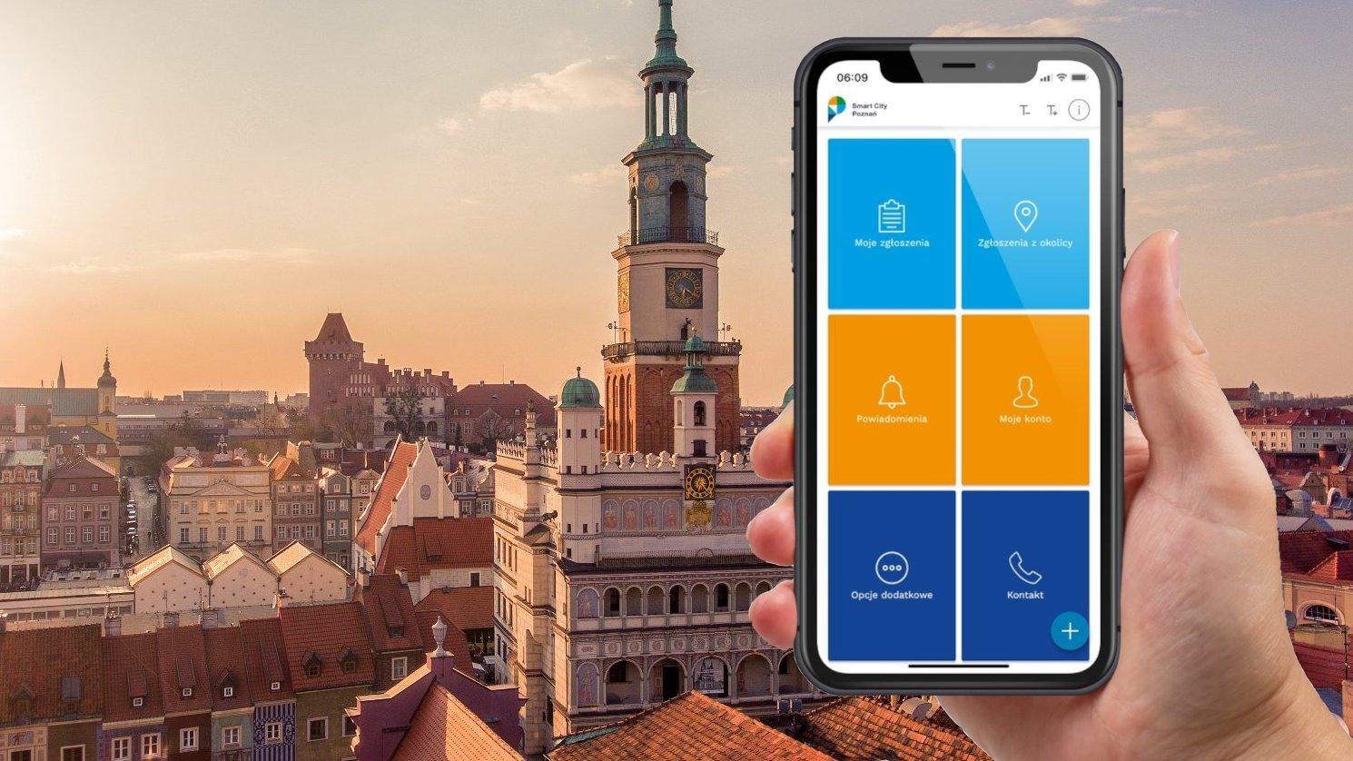 Dłoń trzymająca telefon, w tle panorma Poznania.