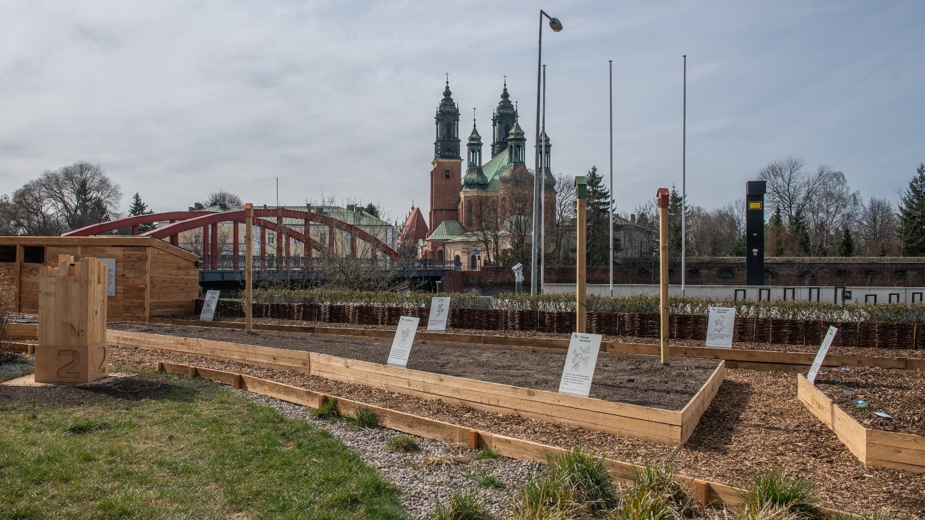 Galeria zdjęć przedstawia ogród eksperymentalny. Widać na nim wydzielone miejsce na rośliny oraz prelegentów konferencji.