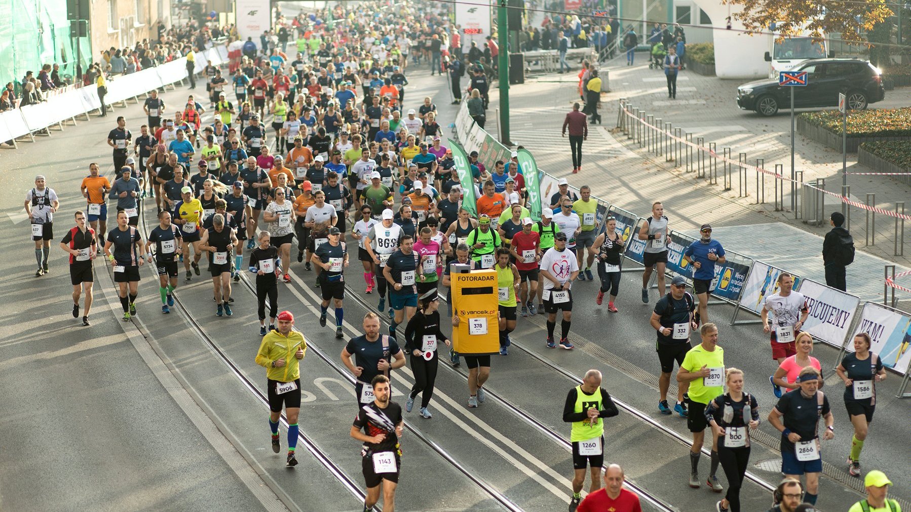 Zdjęcie przedstawia biegaczy podczas startu w poznańskim maratonie.