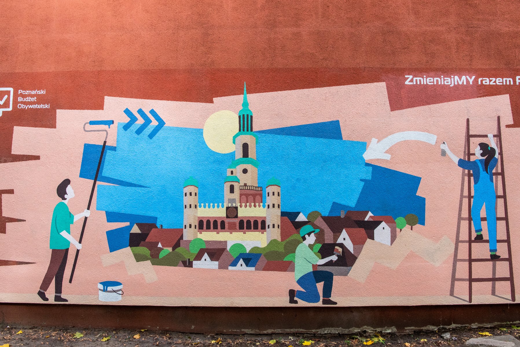 Na zdjęciu mural, przedstawiający dzieci malujące Poznań na ścianie - grafika rozmowy