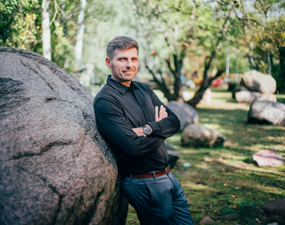 a man leaning against the big rock